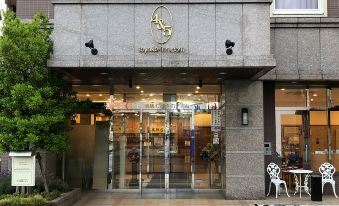 "the entrance to a store called "" a & f "" with a large glass door and several cameras mounted on the wall" at Toyoko Inn Aizuwakamatsu Ekimae